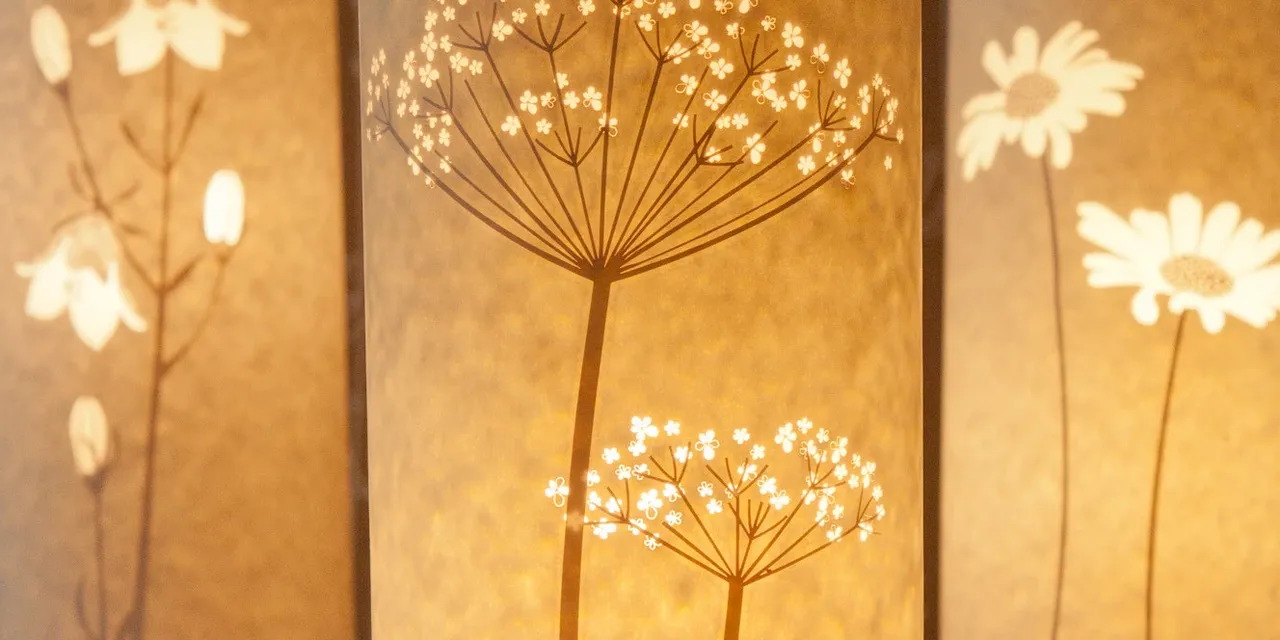 Laser-engraved paper lampshades with floral motifs created using Trotec CO₂ laser cutter