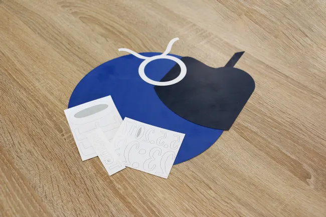 Laser-cut acrylic shapes and labels created with Trotec laser cutter on wooden surface