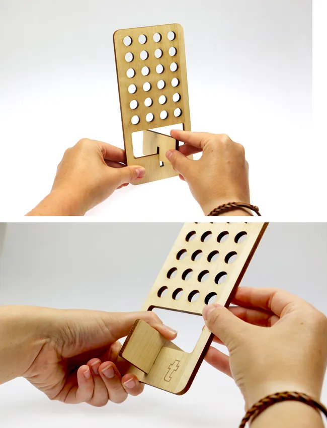 Hands assembling laser-cut wooden phone stand made with Trotec Speedy series laser cutter