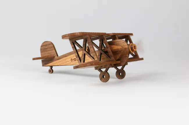 Laser-cut wooden biplane model made with Trotec CO₂ laser engraving machine