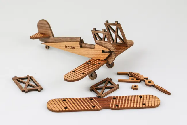 Laser-cut wooden airplane model made with Trotec laser engraving machine