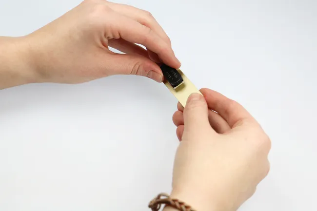 Applying engraved badge created with Trotec laser engraving machine to name tag