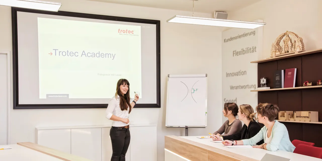 Instructor presenting laser engraving techniques at Trotec Academy training session