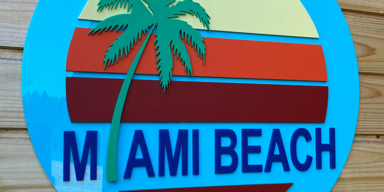 Laser-cut acrylic Miami Beach sign with palm tree, made using Trotec Speedy CO₂ laser engraver