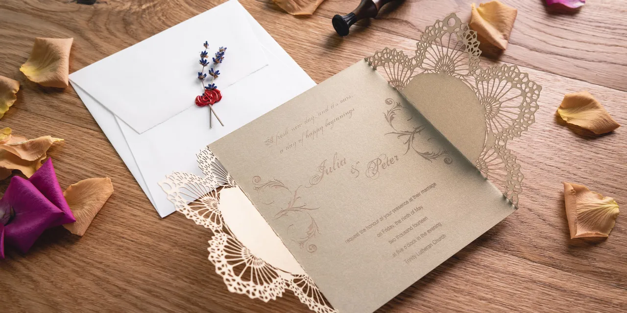 Laser-cut wedding invitation with intricate lace design made using Trotec CO₂ laser engraving machine