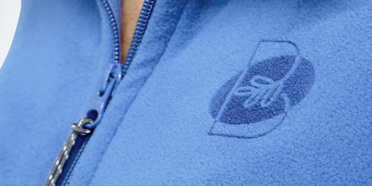 Laser-engraved logo on blue fleece jacket using Trotec CO₂ laser technology