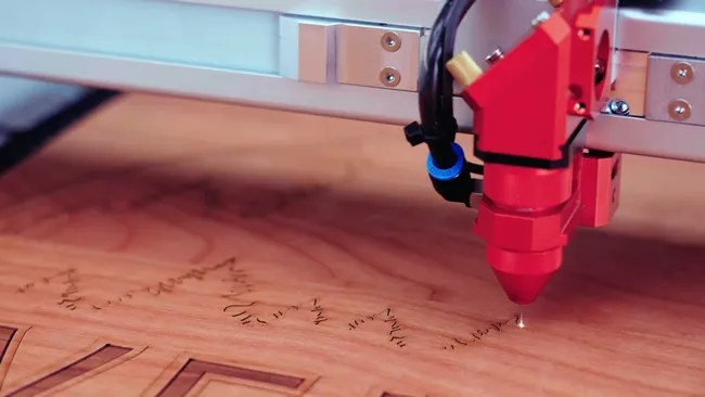 Trotec CO₂ laser cutter engraving detailed text onto wooden surface