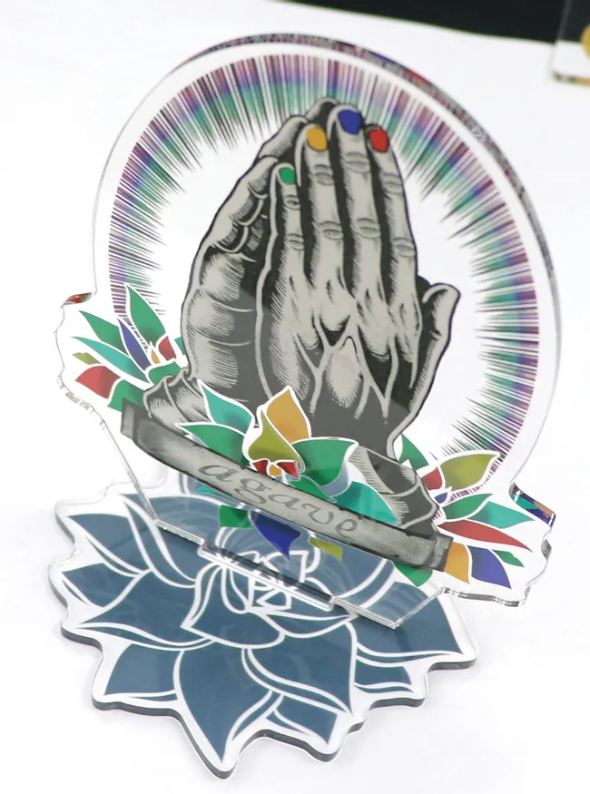 Colorful acrylic artwork with praying hands cut and engraved using Trotec CO₂ laser cutter