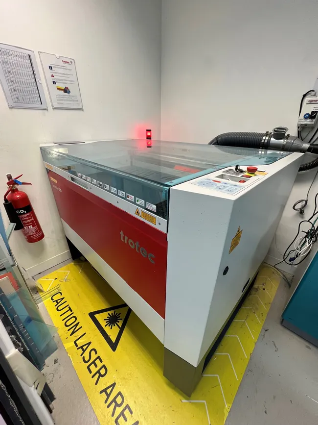 Trotec Speedy 400 CO₂ laser engraving machine in a marked laser safety area