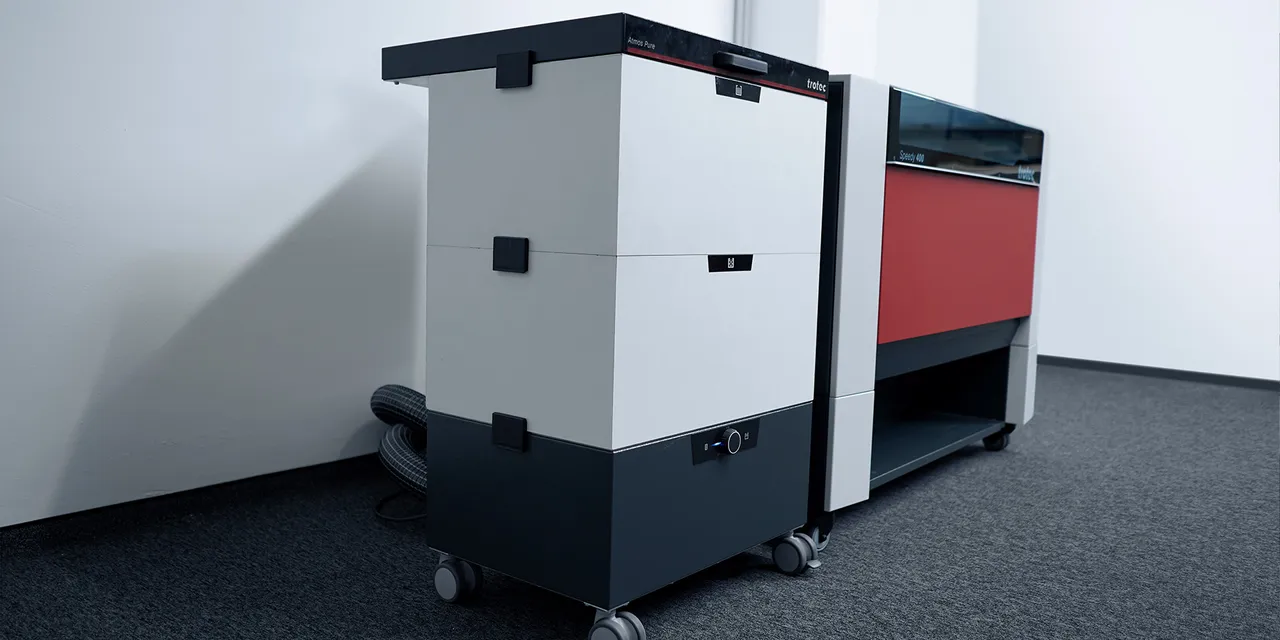 Trotec Atmos Pure exhaust system connected to Speedy 400 laser engraver