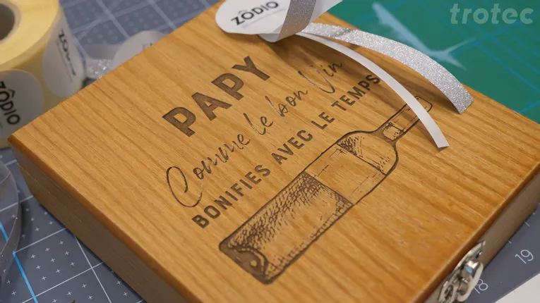 Wooden gift box engraved with Trotec laser cutter featuring wine bottle and French text