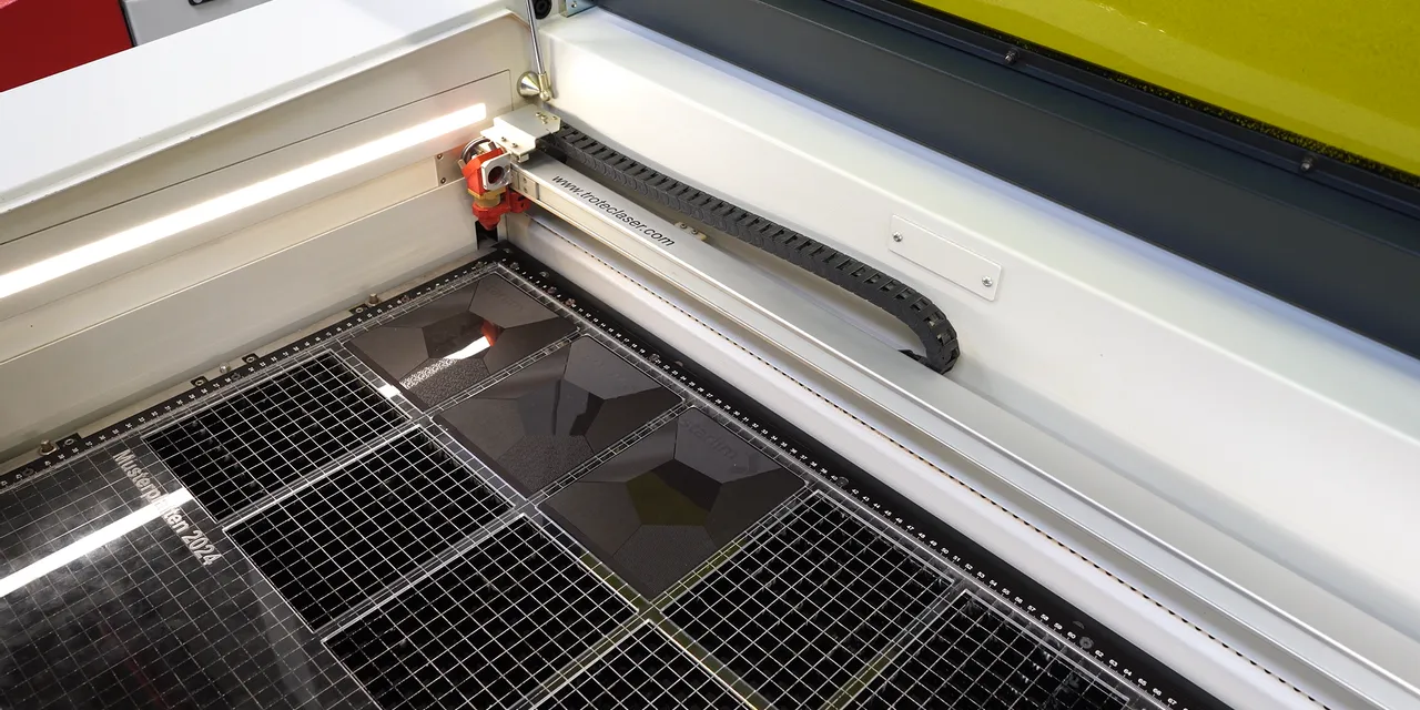 Trotec Speedy series laser cutter engraving acrylic sheets with geometric patterns